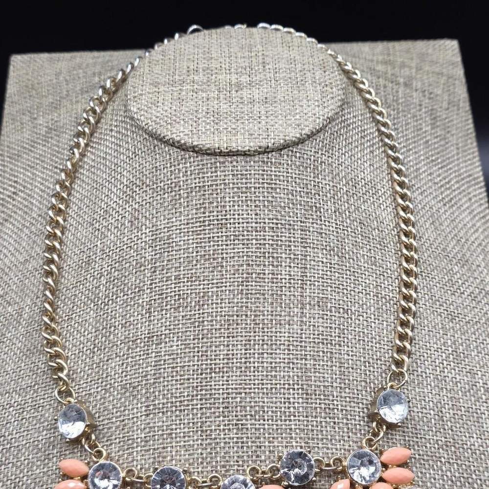 Gold tone necklace with pink and clear rhinestones
